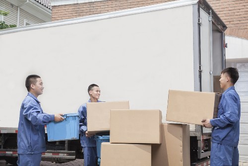 Mover carrying furniture for a flat move in Notting Hill
