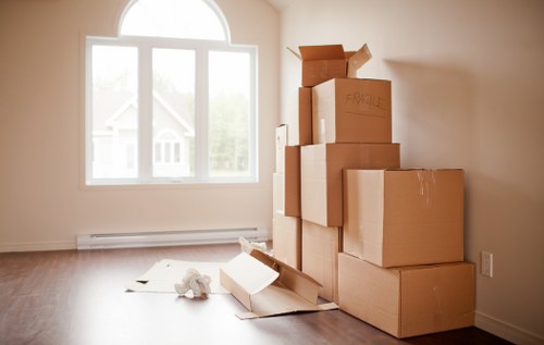 Mover checking boxes and furniture before lifting for transport