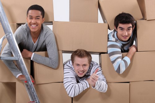 Professional movers carrying furniture in a Notting Hill flat