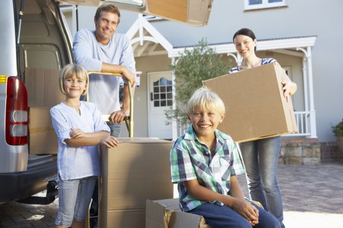 Local van removals team handling boxes and household items in W11