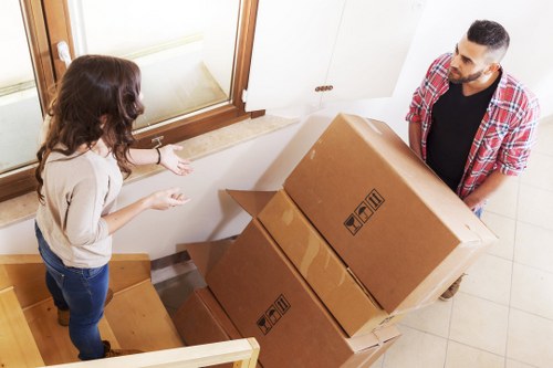Packed moving boxes and careful handling in a Notting Hill home
